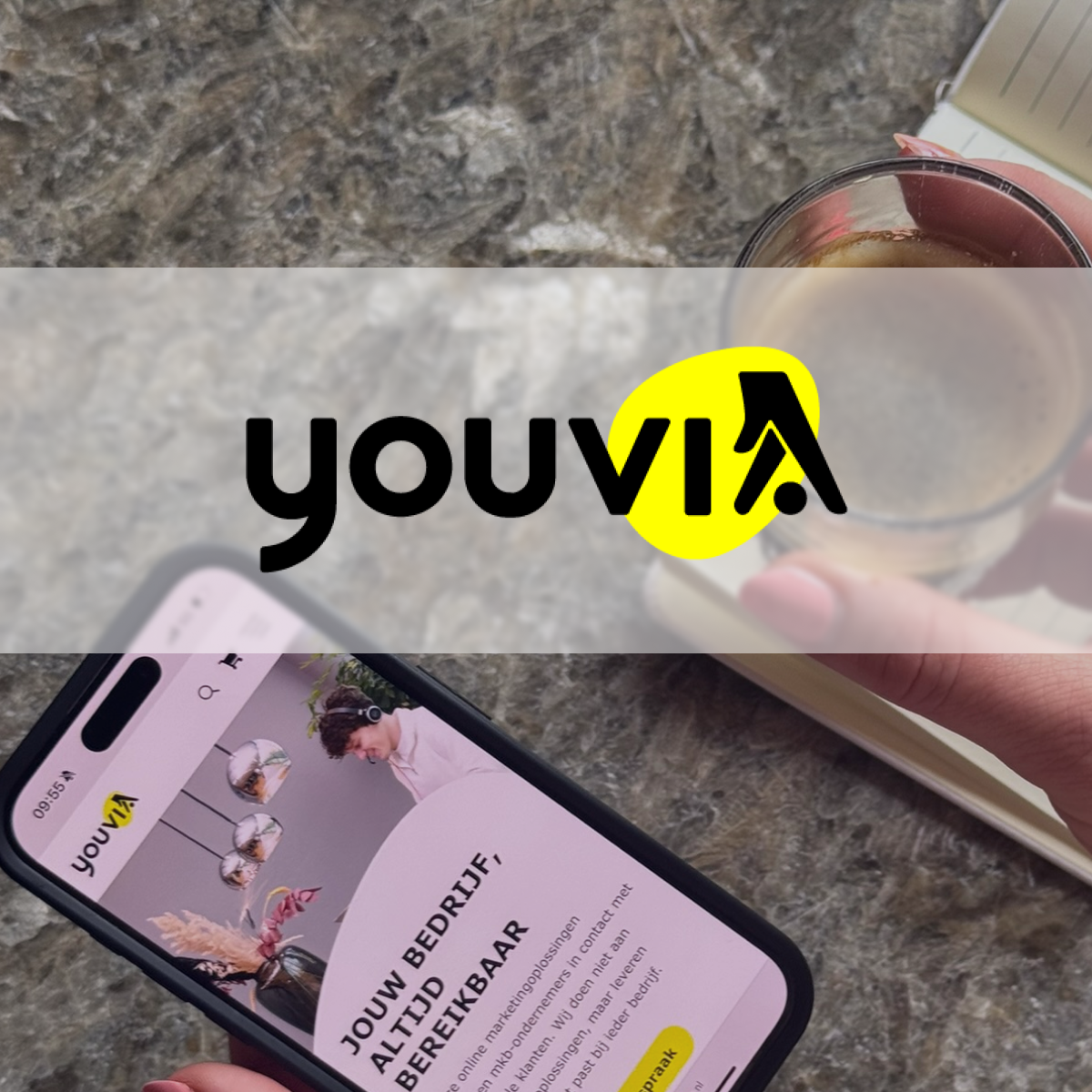 Youvia's logo overlaid a photo of a smart phone and a cup of coffee